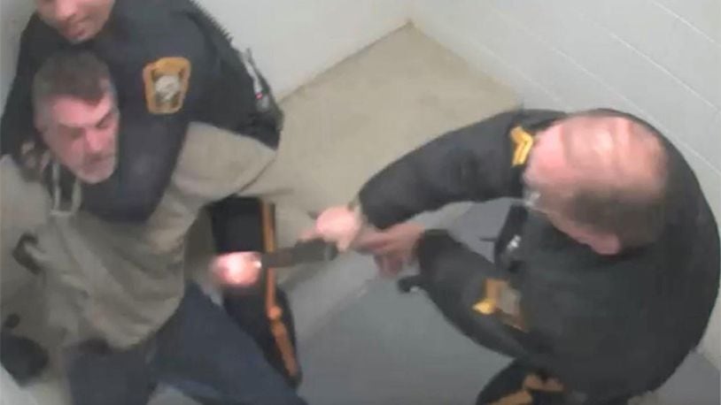 This screenshot from surveillance video released by the Bucks County District Attorney's Office shows the moment when a now-retired police officer with the New Hope Police Department in Pennsylvania mistook his service weapon for a Taser and shot a suspect in March 2019.