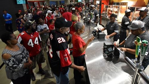 Fans wait to buy foods at during an Atlanta Falcons game at Mercedes-Benz Stadium in its opening season.