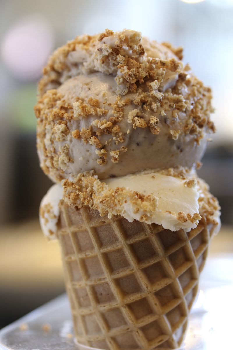 A customer favorite is Honeysuckle Gelato's brown butter gelato. Here it's served in a cone topped with honey fig gelato and sprinkled with amaretti crumbles.