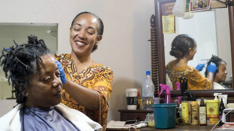 Hairstylist Erica Blevins (right) retwists Gwendolyn Pilot’s locks at the Oh My Nappy Hair salon in downtown Atlanta. Blevins’ mother opened the first location in Oakland, Calif., in 1987 to provide black women with an alternative to the harsh chemicals in hair care products on the market. A recent study found that black women are more likely to be exposed to dangerous chemicals in the hair care products they use.