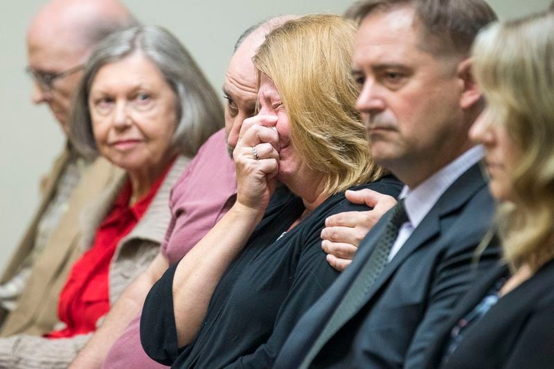 10/14/2019 -- Decatur, Georgia -- Kathy Olsen, wife of Robert "Chip" Olsen, is consoled as the verdict for her husband's trial is read in front of DeKalb County Superior Court Judge LaTisha Dear Jackson at the DeKalb County Courthouse in Decatur, Monday, October 14, 2019.  (Alyssa Pointer/Atlanta Journal Constitution)