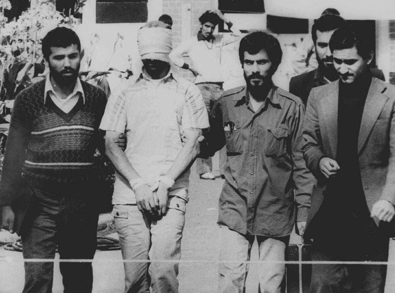 One of 66 American hostages blindfolded with his hands bound is displayed to the crowd outside the U.S. embassy in Tehran on Nov. 9, 1979. Their captors held 52 of the Americans for 444 days. (Associated Press)