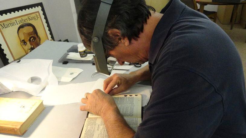 Gordon Ponsford, a conservator and owner of Ponsford Limited, repairs the Martin Luther King Bible that will be used by President Obama during his swearing in for his second term.