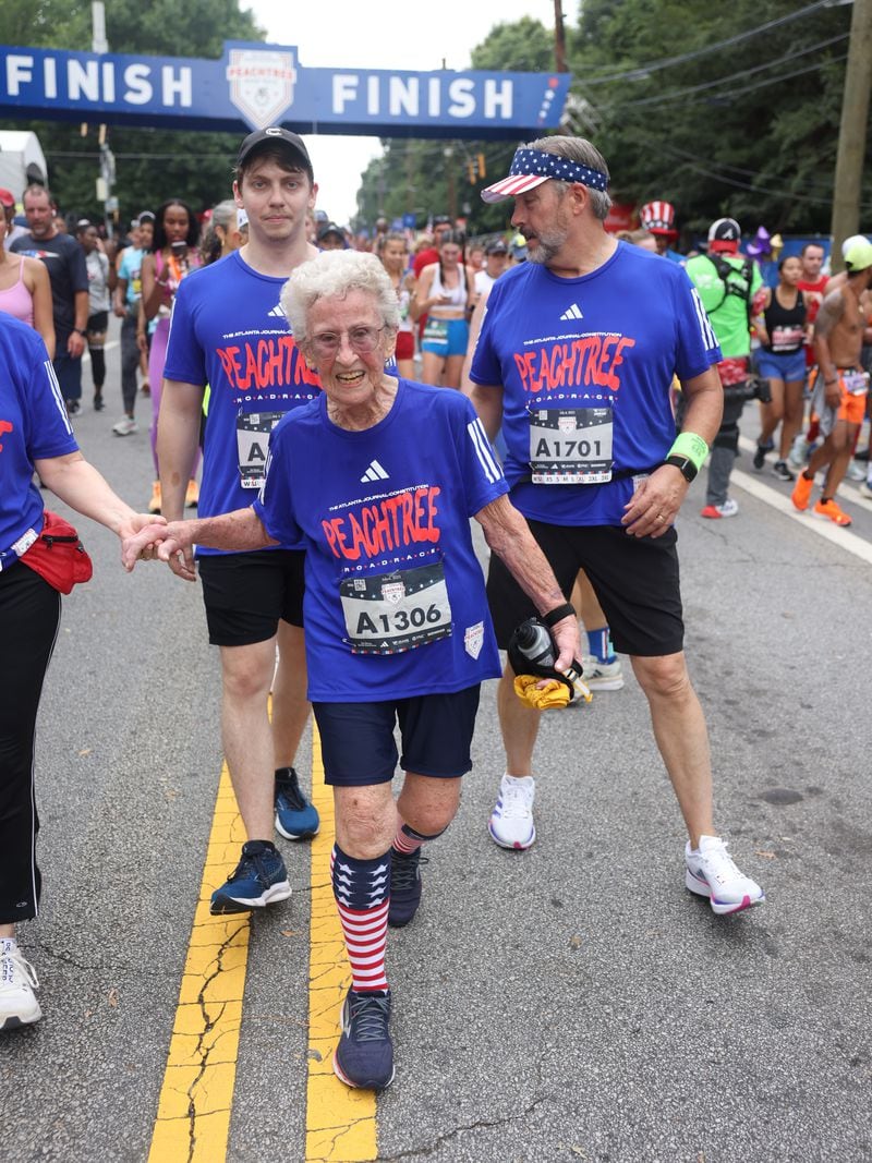 Betty Lindberg, 98, crosses the finish line of the 54th running of the Atlanta Journal-Constitution Peachtree Road Race in Atlanta on Tuesday, July 4, 2023.  Lindberg set the 5K World record in 2022 in the 95-99 age group.  (Jason Getz / Jason.Getz@ajc.com)