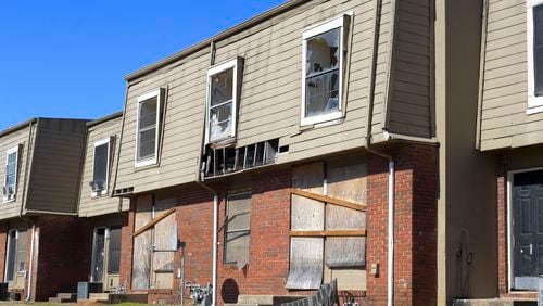 FILE: Broken windows and missing siding are a common site at the Forest Cove apartment complex seen Tuesday, Feb. 1, 2022. (Daniel Varnado/For the Atlanta Journal-Constitution)