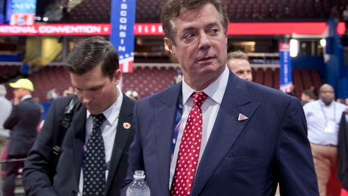 FILE - In this July 18, 2016, file photo, Trump campaign chairman Paul Manafort walks around the convention floor before the opening session of the Republican National Convention in Cleveland. Manafort resigned in wake of campaign shakeup and revelations about Ukraine work. (AP Photo/Carolyn Kaster, File)