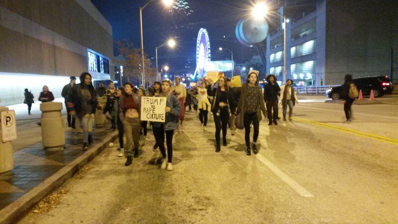 Protesters march by CNN Center  Wednesday night. They took to the streets in downtown Atlanta to protest the election of Donald Trump. MATT KEMPNER/MKEMPNER@AJC.COM