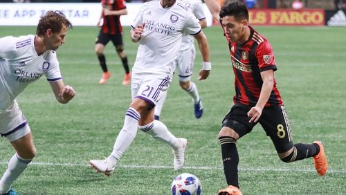 Atlanta United Ezequiel Barco works against two Orlando City defenders during the second half in a MLS soccer match on Saturday, June 30, 2018, in Atlanta.     Curtis Compton/ccompton@ajc.com