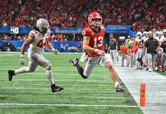 Georgia Bulldogs quarterback Stetson Bennett (13) scores on a keeper during the second quarter of the College Football Playoff Semifinal between the Georgia Bulldogs and the Ohio State Buckeyes at the Chick-fil-A Peach Bowl In Atlanta on Saturday, Dec. 31, 2022. (Hyosub Shin / Hyosub.Shin@ajc.com)