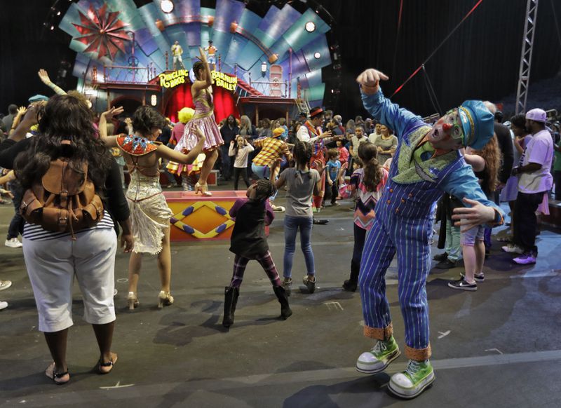 Ringling Bros. and Barnum & Bailey clowns dance with fans during a pre show for fans Saturday, Jan. 14, 2017, in Orlando, Fla. The Ringling Bros. and Barnum & Bailey Circus will end the "The Greatest Show on Earth" in May, following a 146-year run of performances. Kenneth Feld, the chairman and CEO of Feld Entertainment, which owns the circus, told The Associated Press, declining attendance combined with high operating costs are among the reasons for closing. (AP Photo/Chris O'Meara)