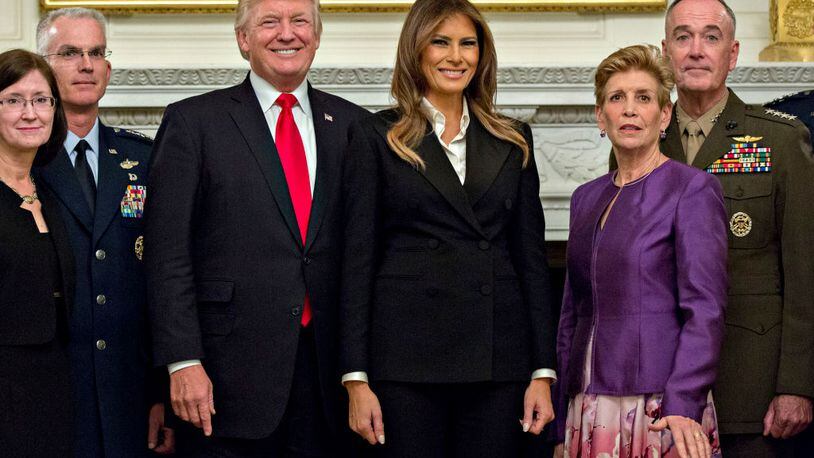 President Donald Trump and first lady Melania Trump pose for pictures with senior military leaders and spouses, including including Gen. Joseph Dunford (right), chairman of the joint chiefs of staff; and General Paul Selva (second from left), vice chairman of the joint chiefs of staff, after a briefing in the State Dining Room of the White House .
