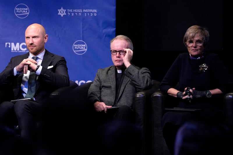 From left, Lawyer Paul Coleman, Catholic priest Father Benedict Kiely and activist Gloria von Thurn-und-Taxis attend the National Conservatism conference in Brussels, Wednesday, April 17, 2024. (AP Photo/Virginia Mayo)