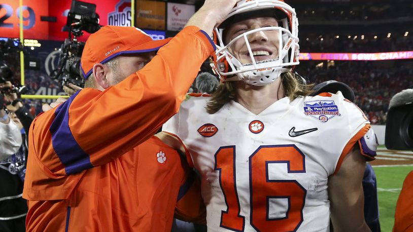 Clemson quarterback Trevor Lawrence (16) is congratulated after Clemson defeated Ohio State 29-23 in the Fiesta Bowl NCAA college football playoff semifinal Saturday, Dec. 28, 2019, in Glendale, Ariz. (AP Photo/Ross D. Franklin)