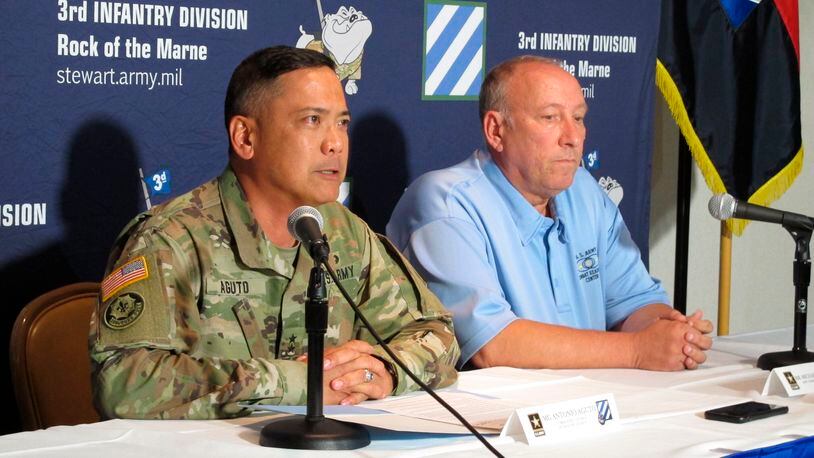 Army Maj. Gen. Antonio Aguto, left, and Army accident investigator Michael Barksdale hold a news conference at Fort Stewart, Ga., about a training accident that killed three soldiers and injured three others. Aguto said the soldiers' armored vehicle rolled off a bridge and landed upside down in a stream during a training exercise being conducted before dawn. The cause of the deadly crash is being investigated.