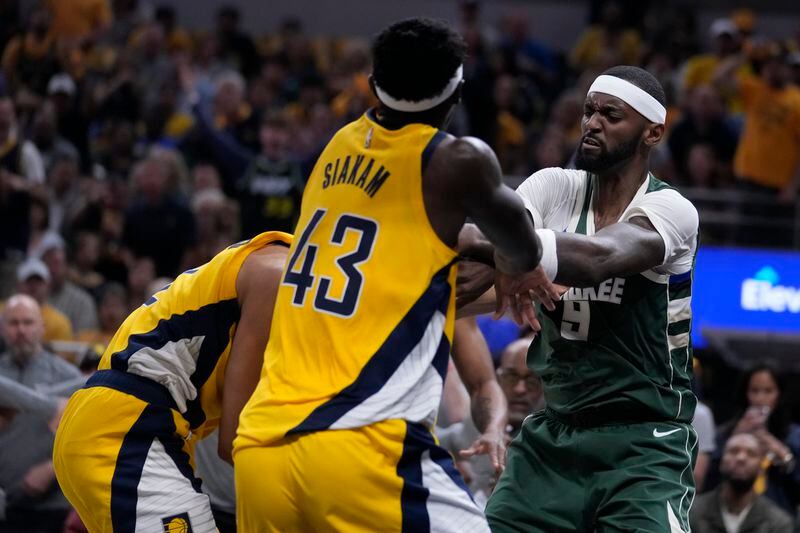 Milwaukee Bucks' Bobby Portis (9) and Indiana Pacers' Andrew Nembhard, left, get into an altercation during the first half of Game 4 of the first round NBA playoff basketball series, Sunday, April 28, 2024, in Indianapolis. (AP Photo/Michael Conroy)