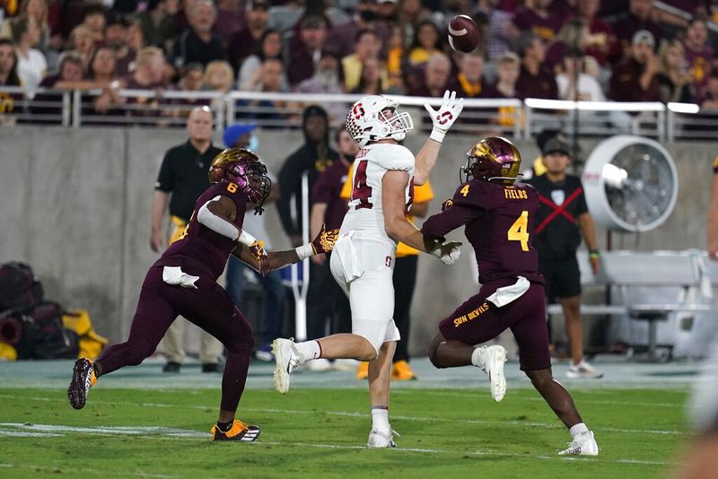 Stanford tight end Benjamin Yurosek, middle, reaches up to make a catch between Arizona State defensive back Evan Fields (4) and Arizona State defensive back Tommi Hill (6) during the first half of an NCAA college football game Friday, Oct. 8, 2021, in Tempe, Ariz. (AP Photo/Ross D. Franklin)