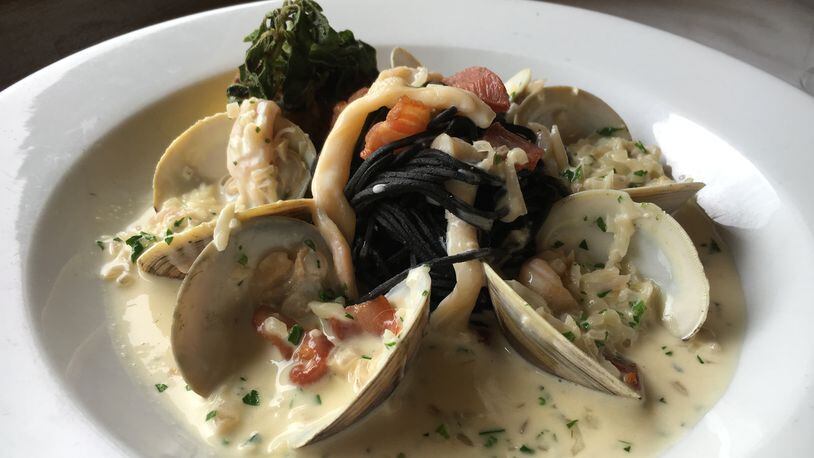 Black Spaghetti Vongole from Portofino in Buckhead. Chef Matt Marcus likes to have a black pasta dish on the menu at all times. This version tops squid ink pasta with chopped Sapelo Island clams cooked with white wine and pancetta. Photo credit: Andrew Thomas Lee