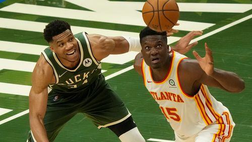 Atlanta Hawks' Clint Capela and Milwaukee Bucks' Giannis Antetokounmpo go after a loose ball during the second half of Game 1 of the NBA Eastern Conference basketball finals game Wednesday, June 23, 2021, in Milwaukee. (AP Photo/Morry Gash)