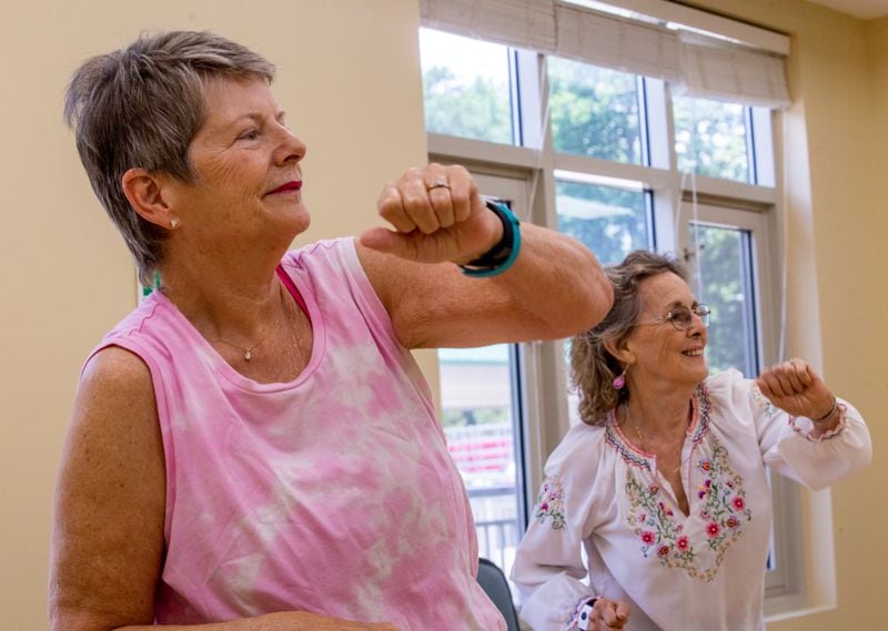 Residents at Canterbury Court including LuAnne Schwarz, from left, and Judy Reidinger attend a popular Zumba class in the aerobics room.  (Jenni Girtman for The Atlanta Journal Constitution)