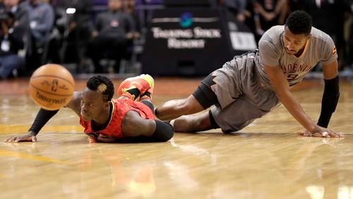 Phoenix Suns guard Leandro Barbosa, right, fouls Atlanta Hawks guard Dennis Schroder during the first half of an NBA basketball game, Wednesday, Nov. 30, 2016, in Phoenix. (AP Photo/Matt York)