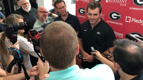 Georgia quarterback Jake Fromm (center) seems completely at ease amid a media scrum during UGA Media Day before the opening of preseason camp Friday afternoon in Athens.