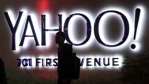 In this Nov. 5, 2014, file photo, a person walks in front of a Yahoo sign at the company’s headquarters in Sunnyvale, Calif. (AP Photo/Marcio Jose Sanchez, File)