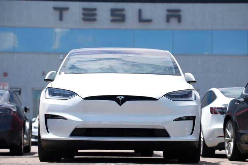 FILE - An 2023 Model X sits outside a Tesla dealership on June 18, 2023, in Englewood, Colo. After reporting dismal first-quarter sales, Tesla is planning to lay off about a tenth of its workforce as it tries to cut costs, multiple media outlets reported Monday. (AP Photo/David Zalubowski, File)