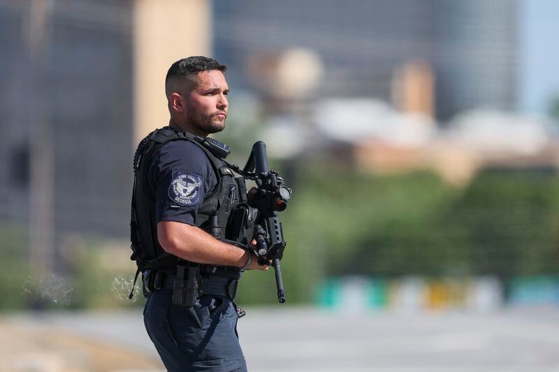A Cobb County Police officer blocks the intersection of Windy Ridge Parkway and Cobb Parkway, Wednesday, May 3, 2023, in Atlanta. Metro Atlanta area police searched near the intersection of Windy Ridge Parkway and Heritage Court. (Jason Getz / Jason.Getz@ajc.com)
