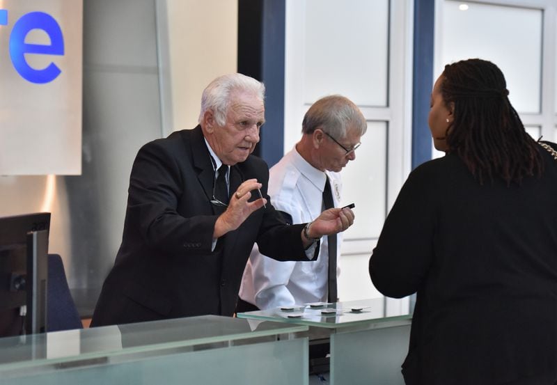 July 23, 2019 Kennesaw - Gary Smith (left), 73, helps a visitor with checking-in at CryoLife, where Smith works as a security officer, in Kennesaw on Tuesday, July 23, 2019. Gary Smith, 73, retired for two years but came back to work at 69, working for Allied Universal, the security company. The future of workers is looking a lot grayer. Older workers are the fastest growing segment of the employed in Georgia and the U.S. The age group adding the largest percentage of workers is those 65 to 74. 75+ are growing fast. (Hyosub Shin / Hyosub.Shin@ajc.com)
