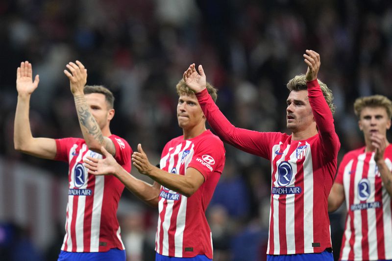 Atletico Madrid players celebrate their victory at the Champions League quarterfinal soccer match between Atletico Madrid and Borussia Dortmund at the Metropolitano stadium in Madrid, Spain, Wednesday, April 10, 2024. (AP Photo/Manu Fernandez)