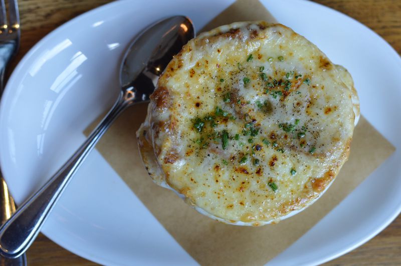 It takes a lot of work for King + Duke’s Coal Roasted Onion Soup to turn out as great as it does. CONTRIBUTED BY HENRI HOLLIS