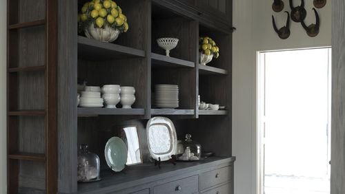 Serveware and other items are tucked away from the kitchen in a custom butler’s pantry with open shelving and drawers. CONTRIBUTED BY Summerour & Associates Architects