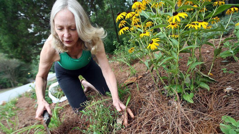Nell Jones transplants perennials at her son's Sandy Springs home. She still wonders, she said, how it was that Mark Barton's bullet missed her that day. The experience "reminded me how small and insignificant we all are on the big scale."