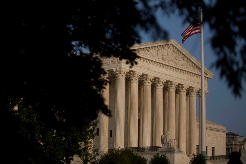 The American flag flies next to the U.S. Supreme Court in Washington, D.C., U.S., on Thursday, June 11, 2015. The U.S. Supreme Court is poised to issue blockbuster rulings on same-sex marriage and health care with both rulings due by the end of June as the court finishes its nine-month term with its traditional flurry of major opinions. Photographer: Andrew Harrer/Bloomberg