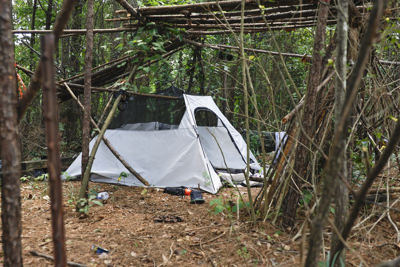Views of a homeless encampment tucked in a wooded area in Norcross on Friday, July 15, 2022. (Natrice Miller/natrice.miller@ajc.com)