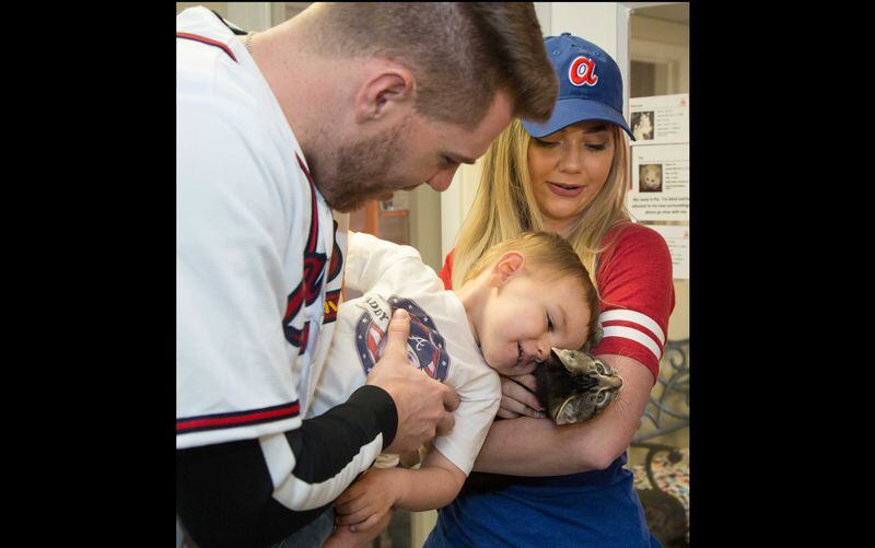 Atlanta Braves baseball player Freddie Freeman and wife Chelsea watched as their son Charlie (age 2) cuddled with a kitten during a visit to Best Friends in Atlanta as part of the team's Season of Giving on Wednesday Dec. 12, 2018. The animal shelter works collaboratively with area shelters, animal welfare organizations and individuals to save the lives of pets in shelters in the South. (Photo by Phil Skinner)