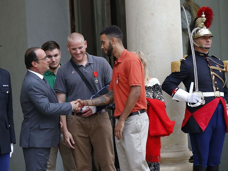 From the left, French President Francois Hollande, bits farewell to U.S. National Guardsman from Roseburg, Oregon, Alek Skarlatos, U.S. Airman Spencer Stone and Anthony Sadler, a senior at Sacramento University in California, at the Elysee Palace in Paris, France, after being awarded with the French Legion of Honor by French President, Francois Hollande, Monday, Aug. 24, 2015. French President Francois Hollande and a bevy of officials are presenting the Americans with the prestigious Legion of Honor on Monday. The three American travelers say they relied on gut instinct and a close bond forged over years of friendship as they took down a heavily armed man on a passenger train speeding through Belgium. (AP Photo/Michel Euler)
