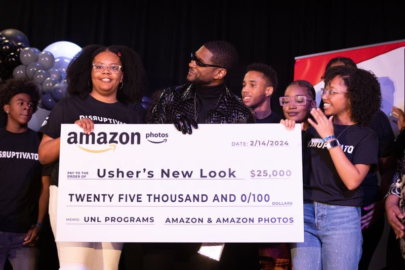 Usher appears with students from his New Look Foundation during a homecoming rally for him at Clark Atlanta University in Atlanta on Wednesday, February 14, 2024. Along with other honors, Amazon presented a $25,000 donation to the New Look Foundation. (Arvin Temkar / arvin.temkar@ajc.com)