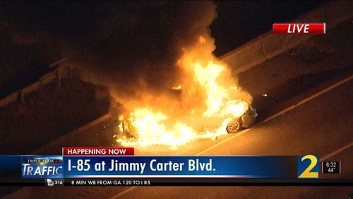 A Toyota Camry burst into flames on I-85 near the Jimmy Carter Boulevard exit Monday morning. The spot was the site of another crash and massive fire that shut down the interstate Saturday.