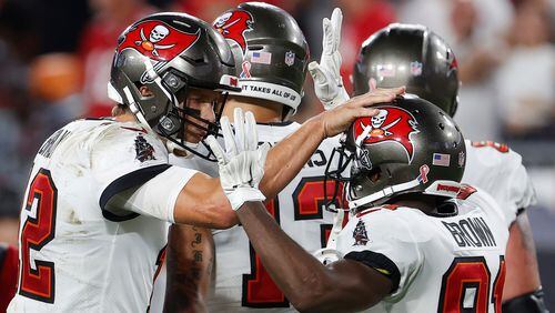 Tampa Bay Buccaneers quarterback Tom Brady (12) celebrates with wide receiver Antonio Brown (81) after a catch against the Dallas Cowboys during the second half Thursday, Sept. 9, 2021, in Tampa, Fla. (Scott Audette/AP)