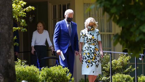 President Joe Biden and first lady Jill Biden walk with former first lady Rosalynn Carter as they leave the home of former President Jimmy Carter during a trip to mark Biden's 100th day in office, Thursday, April 29, 2021, in Plains, Ga. (AP Photo/Evan Vucci)