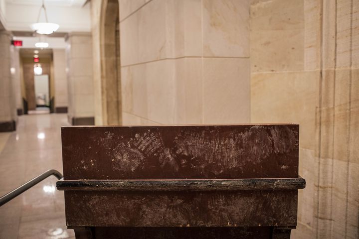 Footprints were left on a riot damaged display case at the Capitol in Washington on Thursday, Jan. 7, 2021. (Jason Andrew/The New York Times)