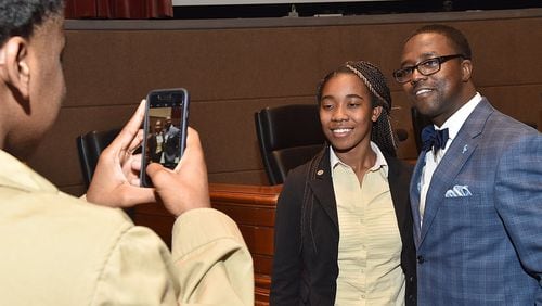 Marquise Byrd, who wants to become a litigator, photographs Gate City Bar Association President Clyde Mize and Skye Williams, who hopes to serve as a Judge Advocate General officer in the military. The South Gwinnett High students attended law firm Morris, Manning & Martin’s summer program for aspiring attorneys. CONTRIBUTED BY DON MORGAN PHOTOGRAPHY
