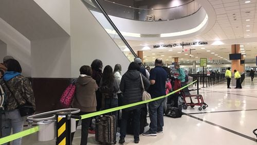 Shortly after power was restored at much of Atlanta's airport on Sunday night, people began lining up at the security checkpoint.