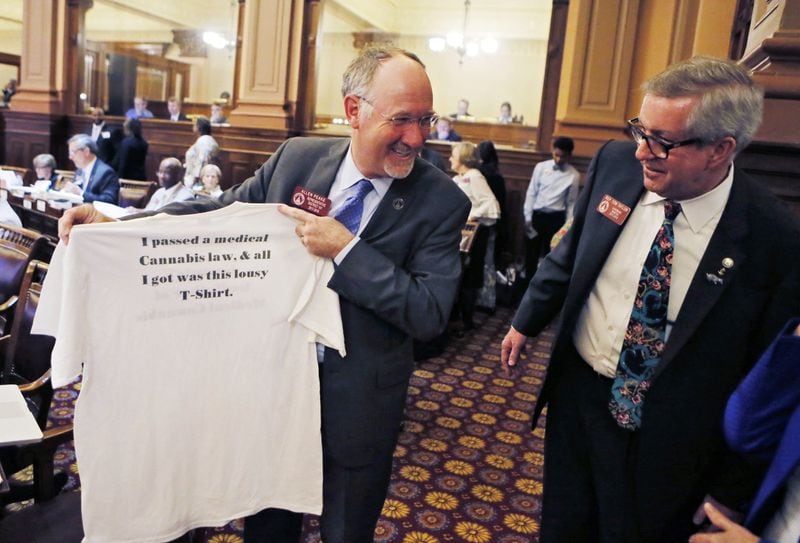 On March 29, 2018 — the 40th and final day of the 2018 General Assembly — then-Rep. Allen Peake, R-Macon (left), shows off a T-shirt presented to him from families who support his sponsorship of medical marijuana legislation. Admiring the T-shirt is Rep. Tom Taylor, R-Dunwoody. 