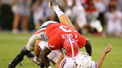 Georgia linebacker Roquan Smith levels Mississippi State quarterback Nick Fitzgerald who just gets the ball off for a incomplete pass during the first half of an NCAA college football game Saturday, Sept. 23, 2017, in Athens, Ga. (Curtis Compton/Atlanta Journal Constitution via AP)