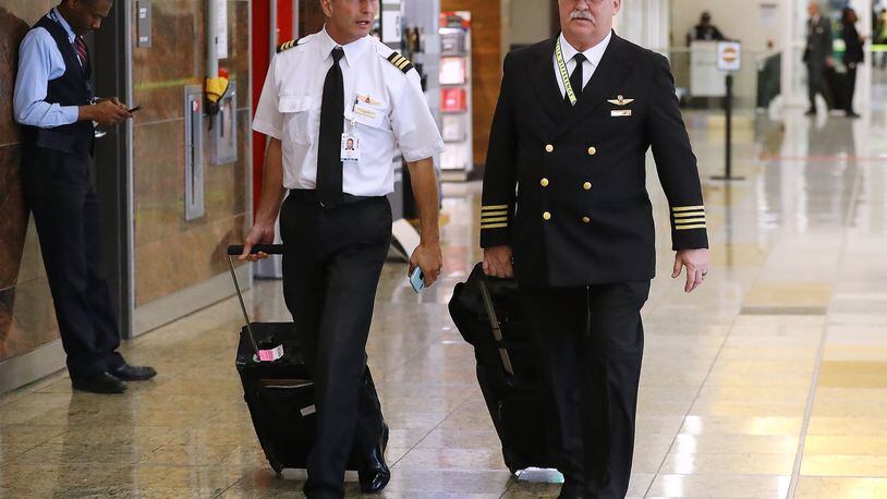 Delta pilots arrive from Stuttgart in the International Terminal at Hartsfield Jackson International Airport earlier this month. The proposed $2 trillion aid package being worked on in Congress has billions for the airline industries. Curtis Compton ccompton@ajc.com
