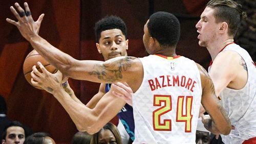 Charlotte Hornets guard Jeremy Lamb looks to pass under pressure from the defense of Atlanta Hawks forward Kent Bazemore (24), and forward Mike Muscala, right, during the first half of an NBA basketball game, Tuesday, April 11, 2017, in Atlanta. (AP Photo/John Amis)