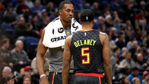 Dwight Howard talks with Malcolm Delaney of the Atlanta Hawks during the game against the Minnesota Timberwolves on December 26, 2016 at Target Center in Minneapolis, Minnesota. (Photo by Jordan Johnson/NBAE via Getty Images)