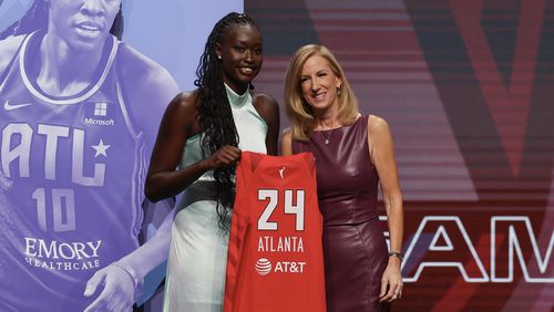 Australia's Nyadiew Puoch, left, poses for a photo with WNBA commissioner Cathy Engelbert after being selected 12th overall by the Atlanta Dream during the first round of the WNBA basketball draft on Monday, April 15, 2024, in New York. (AP Photo/Adam Hunger)